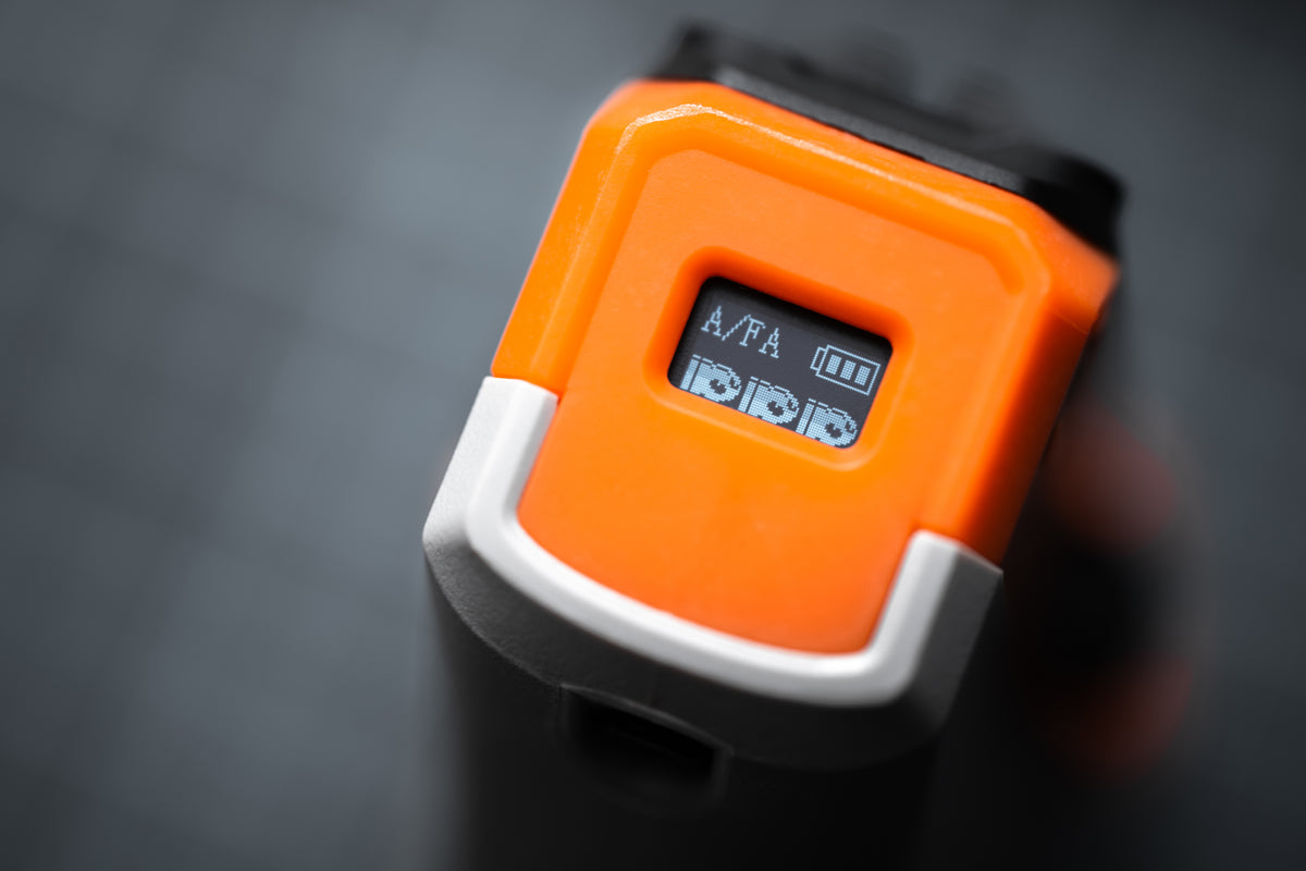 Close-up of the ATROX OLED display showing blaster settings and battery level