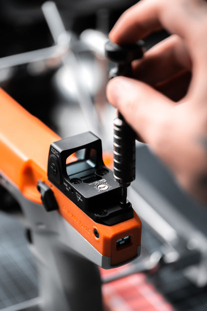 Close-up of the ATROX foam dart blaster red dot sight being installed